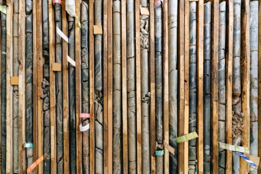 What is core drilling in mineral exploration?